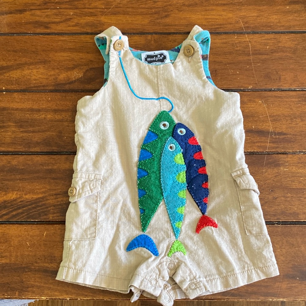 Lightly worn mud pie overalls. Tan blue green in color. Buttons at legs